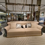 Cream Curved Sofa with Diamond-Quilted Backrest, Dark High-Gloss Sides and Teal Accent Panels